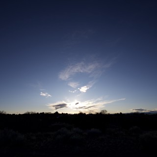 Twilight Sky Over Desert Landscape with Wispy Clouds
