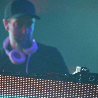 DJ Performs Behind Glowing LED Stage Setup