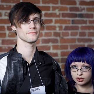 Purple-haired Duo Poses on Brick Building
