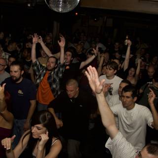 Partygoers Raise the Roof Under the Disco Ball