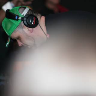 Man in Green Hat Grooving with Headphones
