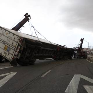 Crane Hoists Overturned Truck on Tarmac