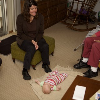 Three Generations Gathered Around a Newborn Baby