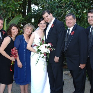 Joyful Wedding Party Portrait in Lush Garden Setting