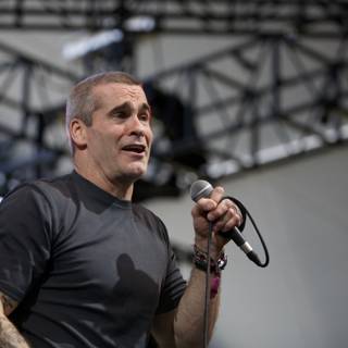 Henry Rollins Takes the Stage with Mic in Hand