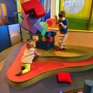 Children Playing with Colorful Building Blocks at Interactive Museum