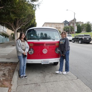 Two Friends Posing with Classic Volkswagen Bus