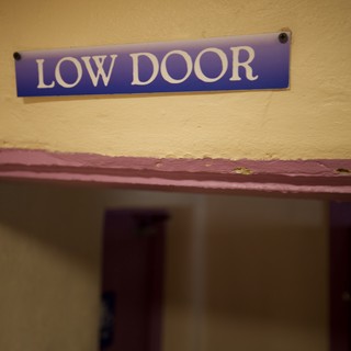 Low Door Sign in Historic Building