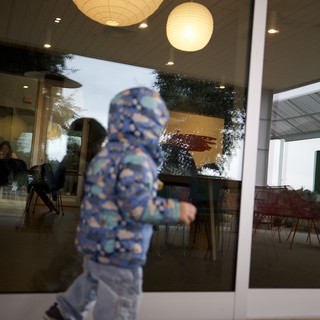 Child in Motion Outside Modern Restaurant