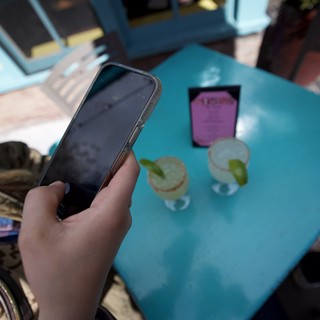 Phone Check at Outdoor Cafe Table