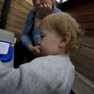 Tender Moment Between Parent and Child on Wooden Deck