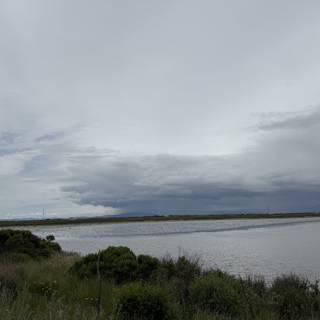 Tranquil Waters Under a Clouded Sky