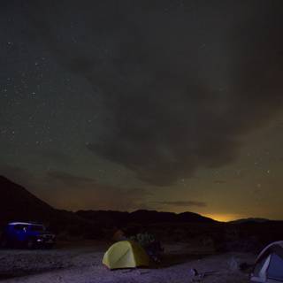 Nighttime Campsite with Car and Tent