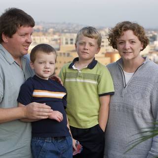 Family Portrait on Rooftop Overlooking City Skyline