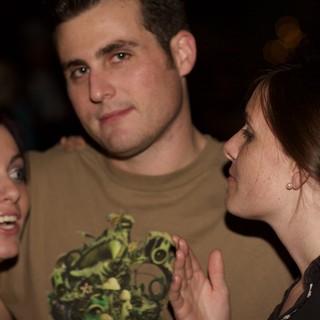 Three Friends Share a Moment at a Evening Gathering