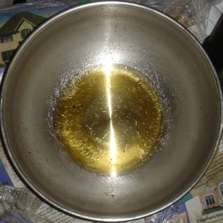Golden Oil in Sleek Metal Bowl