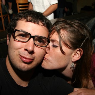 Spontaneous Kiss on the Cheek at a Bar