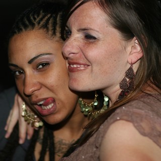 Two Friends Sharing a Joyful Moment at Nightclub