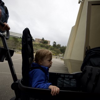 Young Child in Blue Hoodie Sitting in BOB Stroller