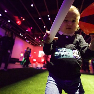 Toddler with Light Sword at Baby Rave Event