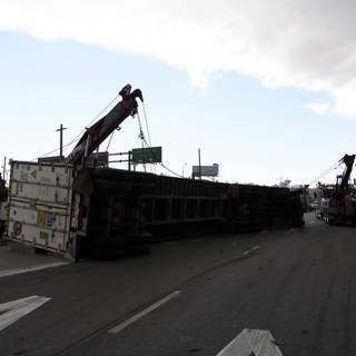 Rescue Mission: Crane Lifts Overturned Truck Off Roadway