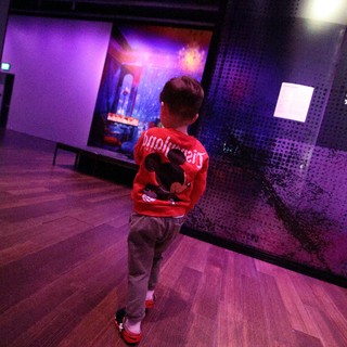 Child in Red Jacket at Baby Rave Museum Event