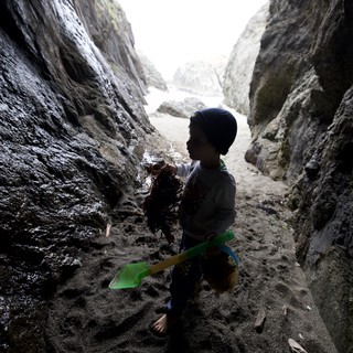 Young Explorer in Sea Cave with Seaweed Treasure
