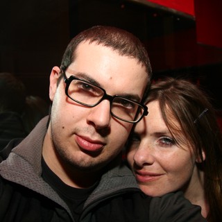 Couple Poses Close Together at Nightclub Event
