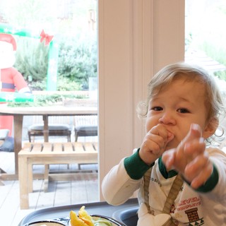 Toddler Reaching Toward Camera at Christmas Time