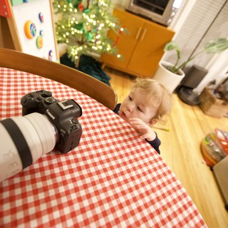 Curious Toddler Inspects Camera on Christmas Morning