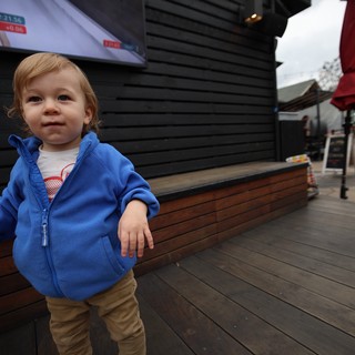 Toddler in Blue Hoodie at Outdoor Venue
