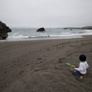 Solitary Child Gazing at the Pacific Ocean Shore