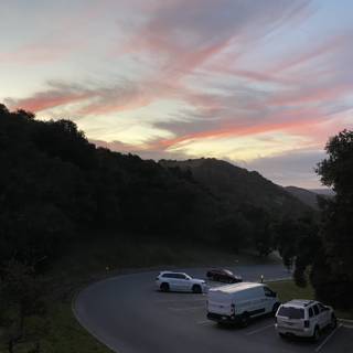 Serene Sunset with Cars Lined on the Road