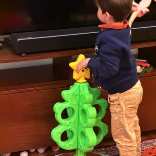 Toddler Playing with Bright Christmas Tree Toy
