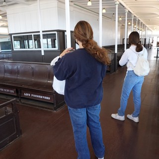 Visitors Exploring Historic Ship Interior Display