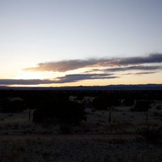 Desert Sunset Over Distant Mountains at Dusk