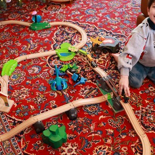 Young Boy Playing with Wooden Train Set on Christmas