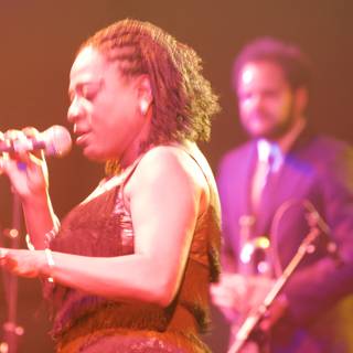 Concert Performance: Woman Singing and Man Playing Saxophone