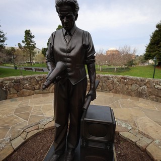 Bronze Statue of Man with Television at Memorial Site