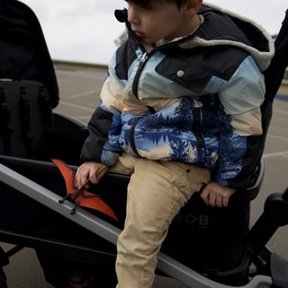 Young Boy Climbing onto Truck at Parking Lot