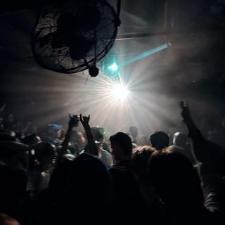 Crowd Bathed in Dramatic Stage Lights at Night Concert