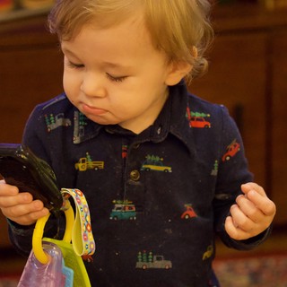Toddler Exploring Vegetables with Curious Expression