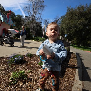 Young Boy with Toy at Fantasyland Theme Park