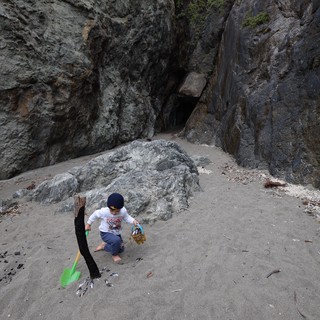 Young Explorer Discovers Sea Cave on Rugged Beach