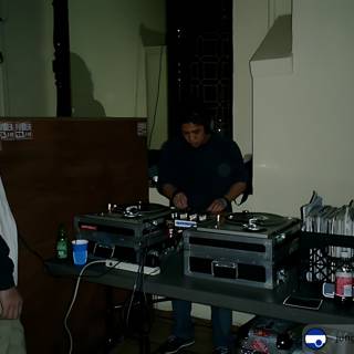 Two Men Enjoying a Performance by a Deejay