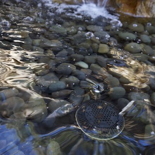 Rippling Stream Over Smooth River Stones