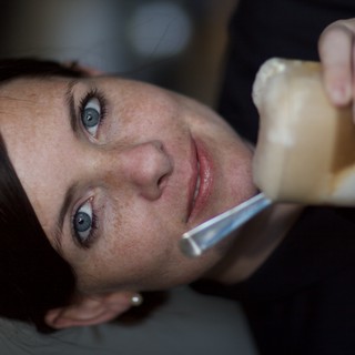 Blue-Eyed Woman Savoring an Iced Coffee Drink