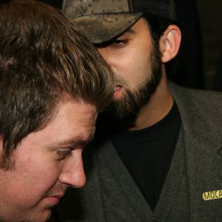 The Bearded Gentlemen Caption: Two men rock their hats and formal wear with some extra scruff on the face.