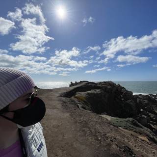 Woman on Clifftop Wearing Face Mask