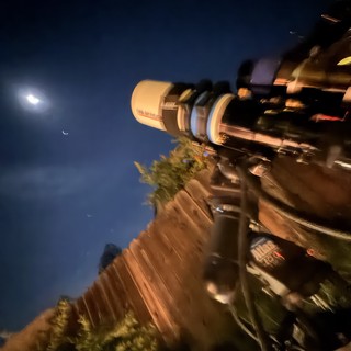 Telescope Observation Under Crescent Moon and Venus